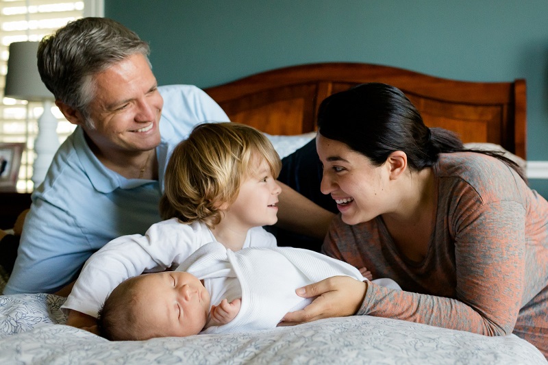 Mom Dad and kids smiling - Radon levels are rising- Get radon inspection to decrease radon gas worries 