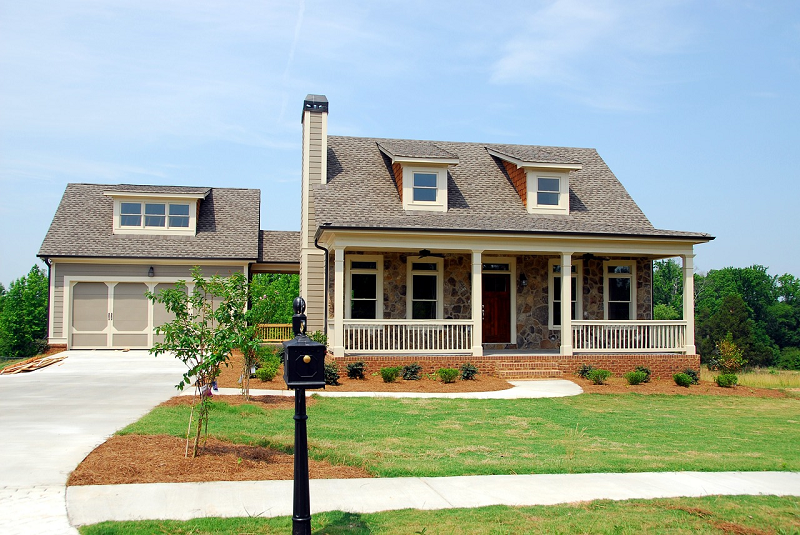 Home with garage and front yard - Radon gas can seep in through foundations and cracks - Radon-Rid, LLC