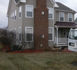 Radon FAQ | Radon-Rid, LLC van in front of two story home